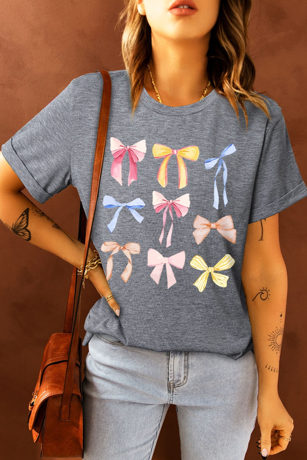 Gray T-shirt with colorful bow graphic design, front view