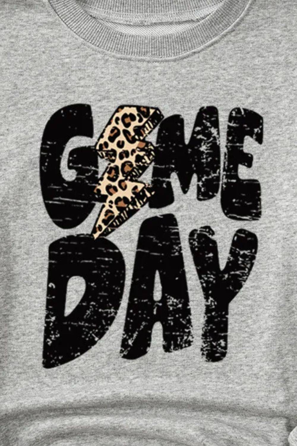 Close-up of GAME DAY sweatshirt with leopard print detail