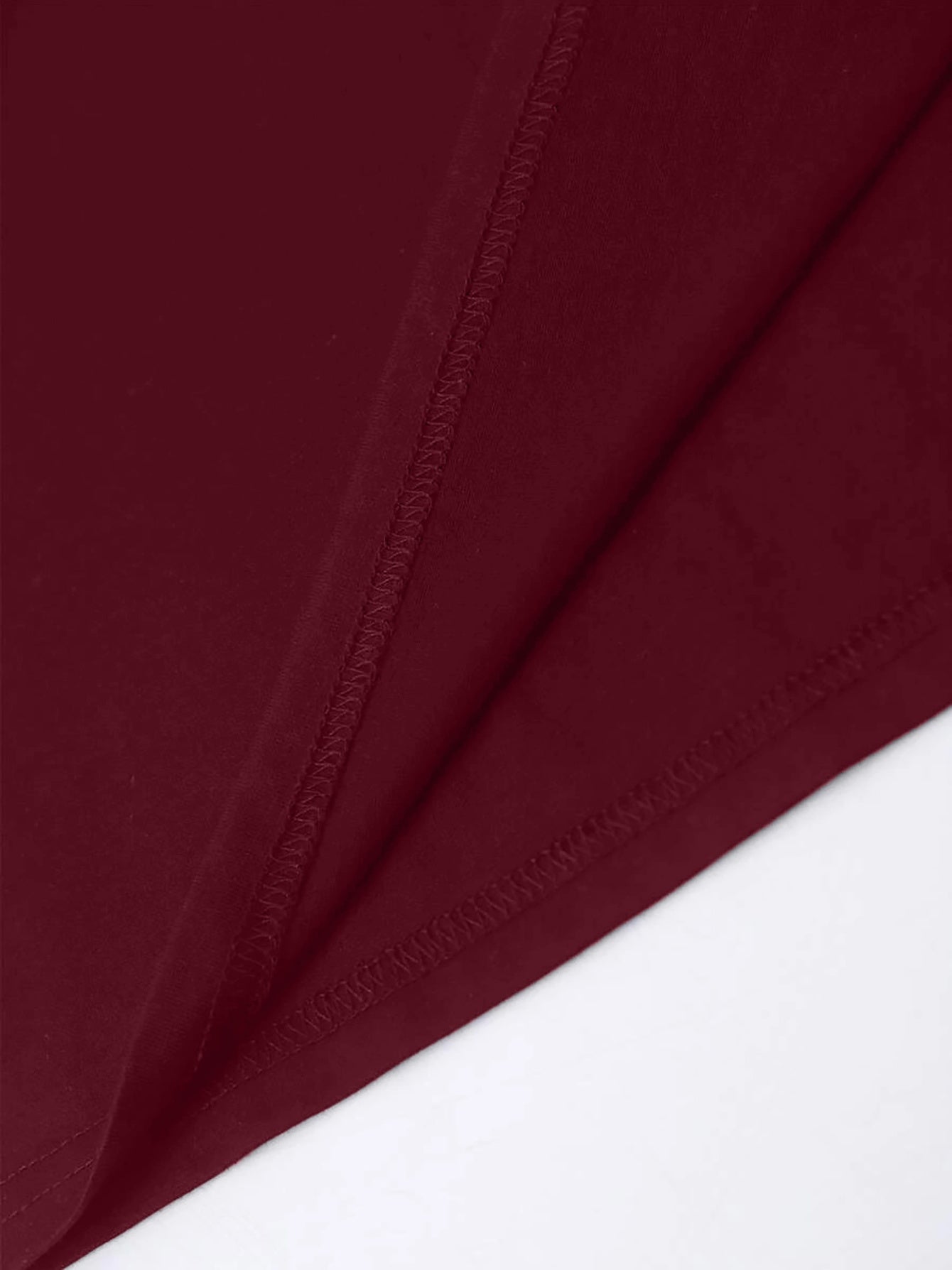 Close-up of maroon T-shirt fabric and stitching