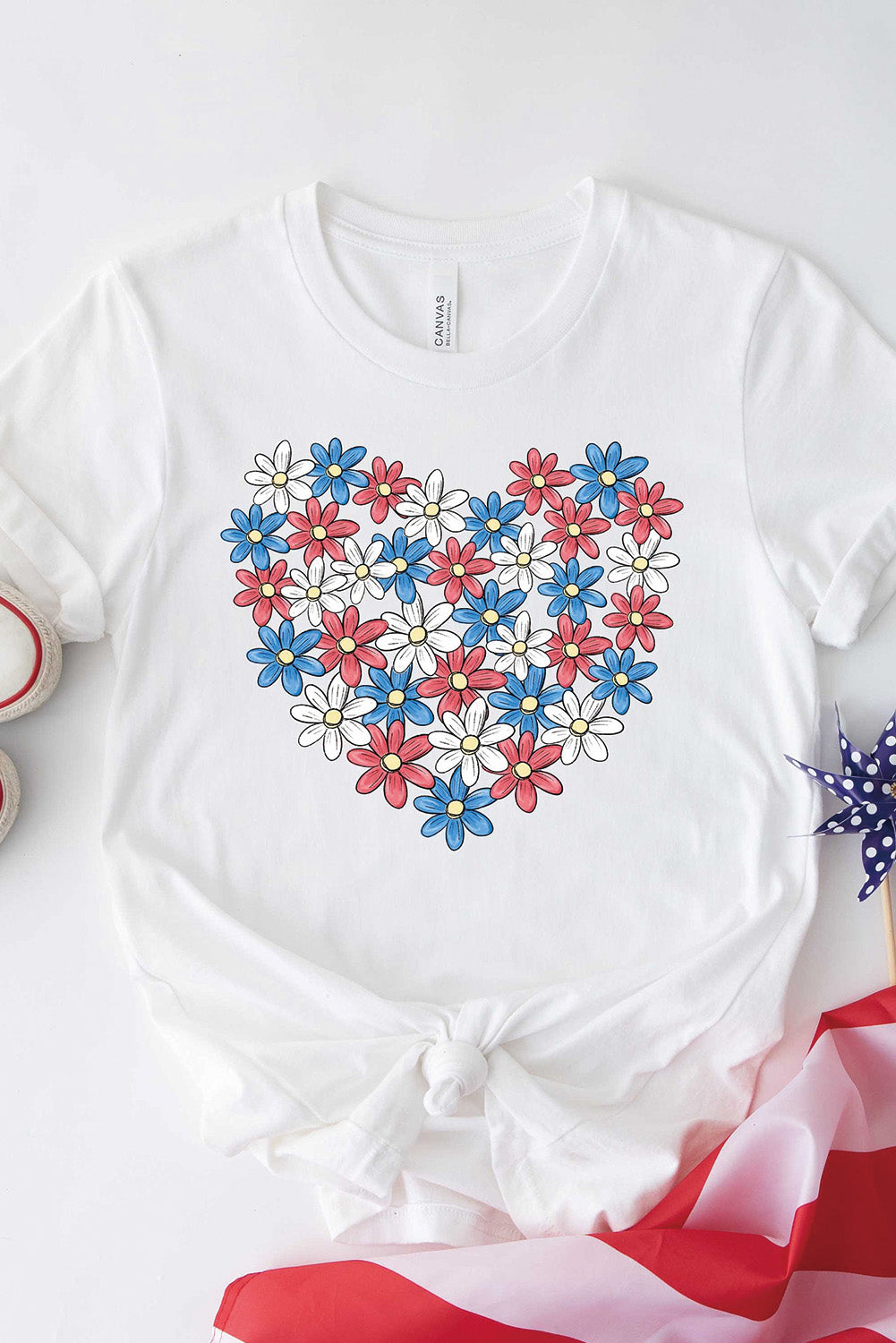 Flat lay of T-shirt with heart-shaped flower graphic.