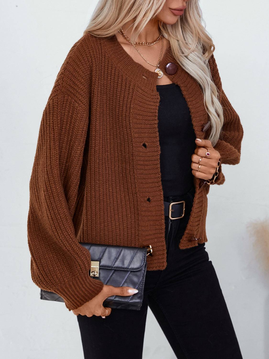 Brown cardigan styled with black top and clutch