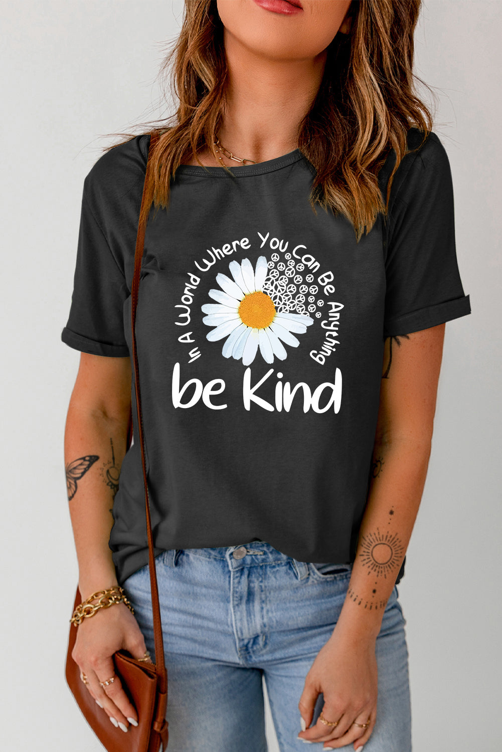 Black T-shirt featuring daisy graphic and &