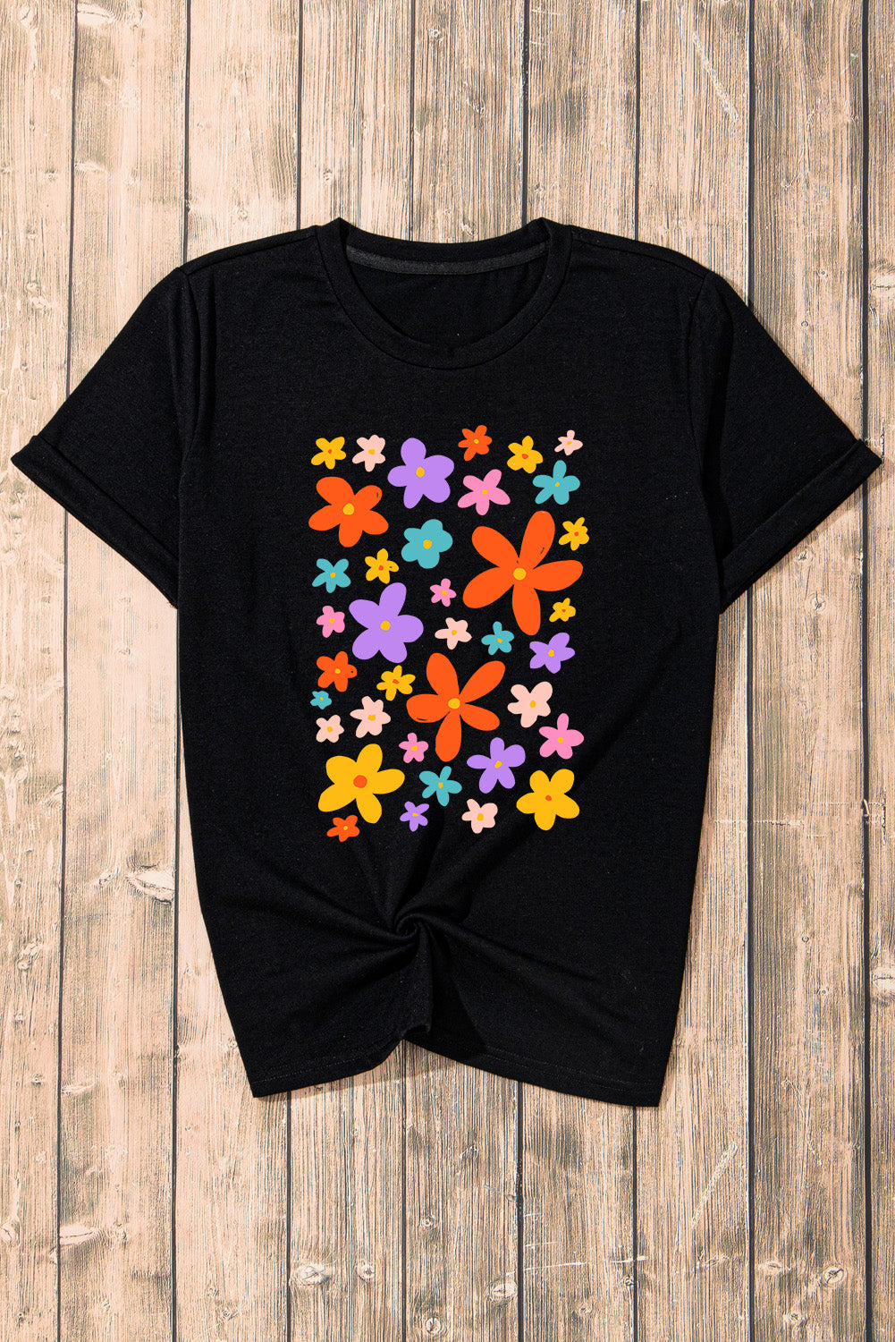 Flat lay of black T-shirt with colorful flower pattern