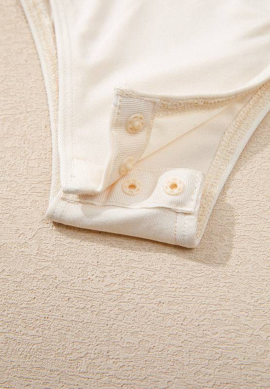 Snap closure detail on bodysuit bottom
