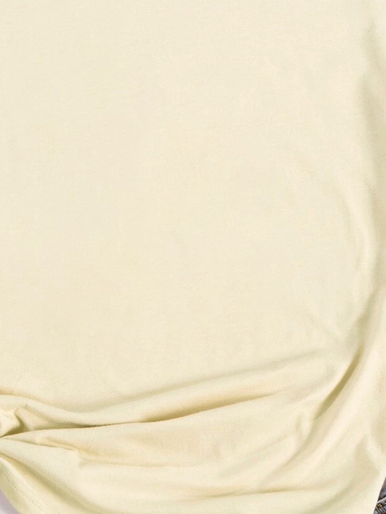 Close-up of cream LUCKY t-shirt fabric detail