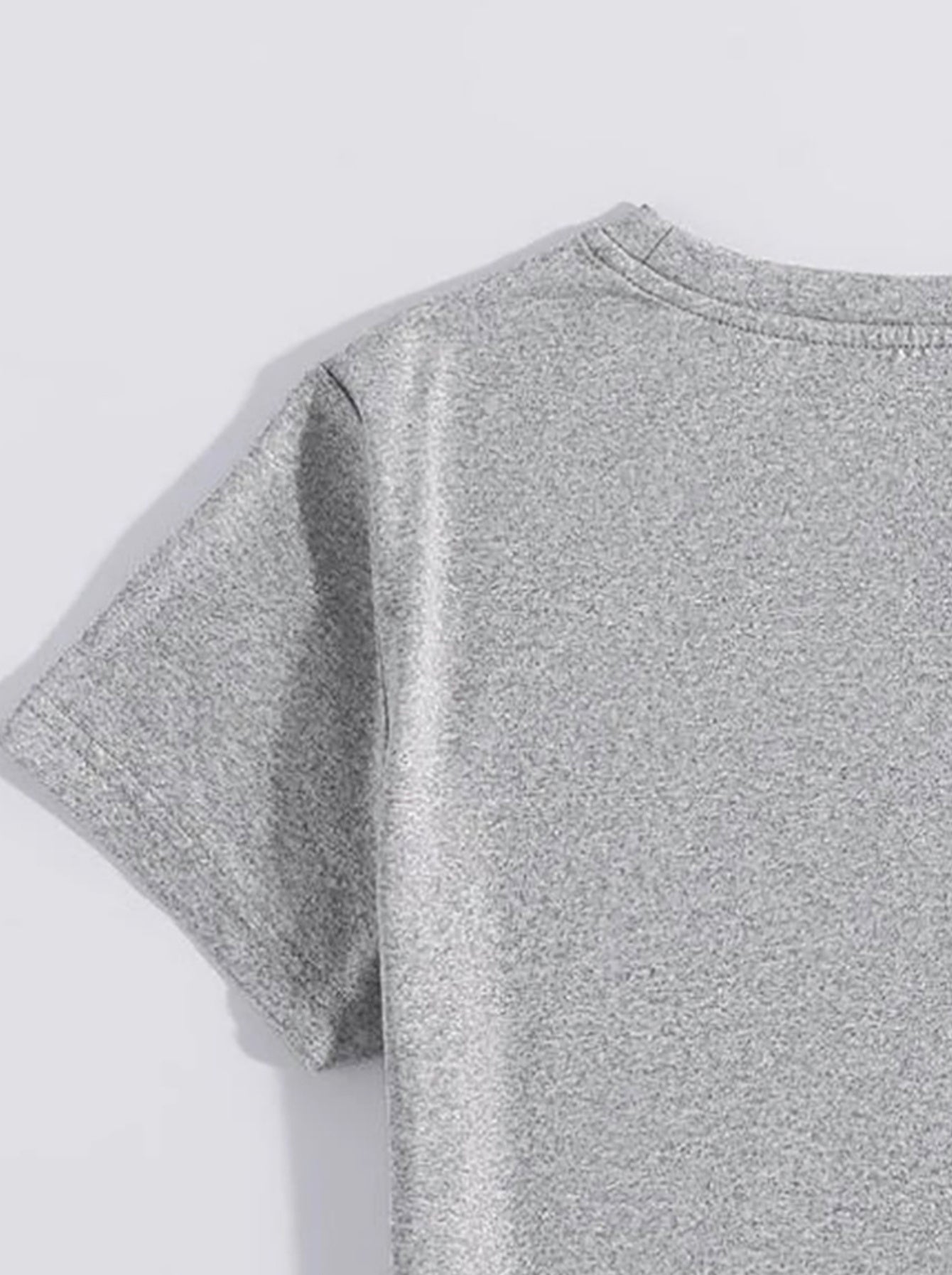 Close-up of light gray short sleeve t-shirt fabric