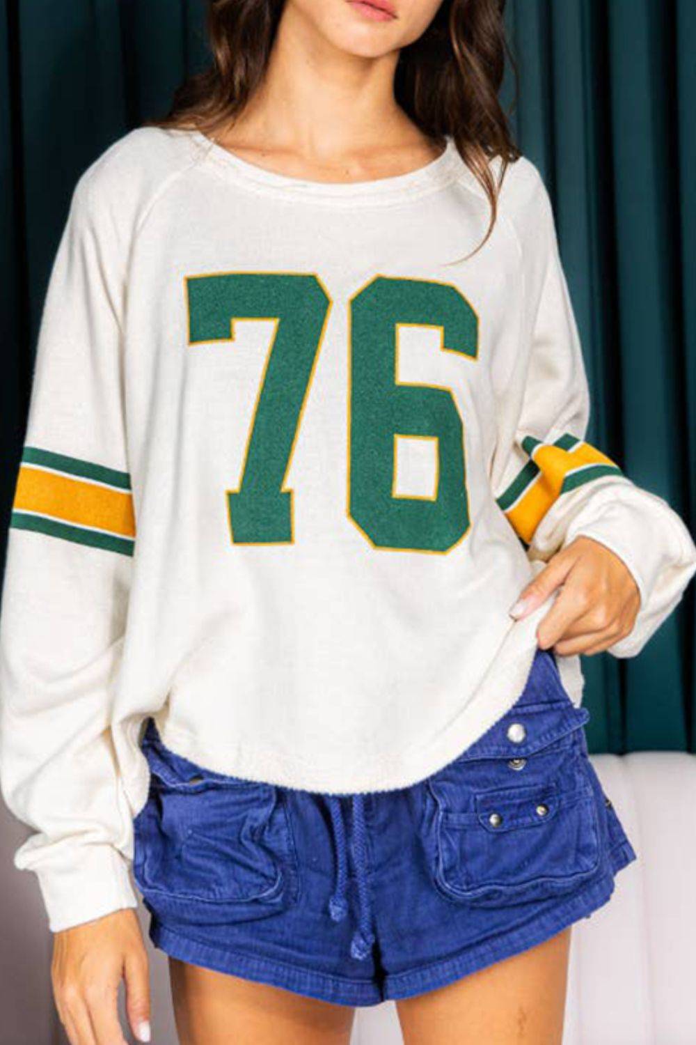 Number 76 long sleeve top with green and yellow stripes