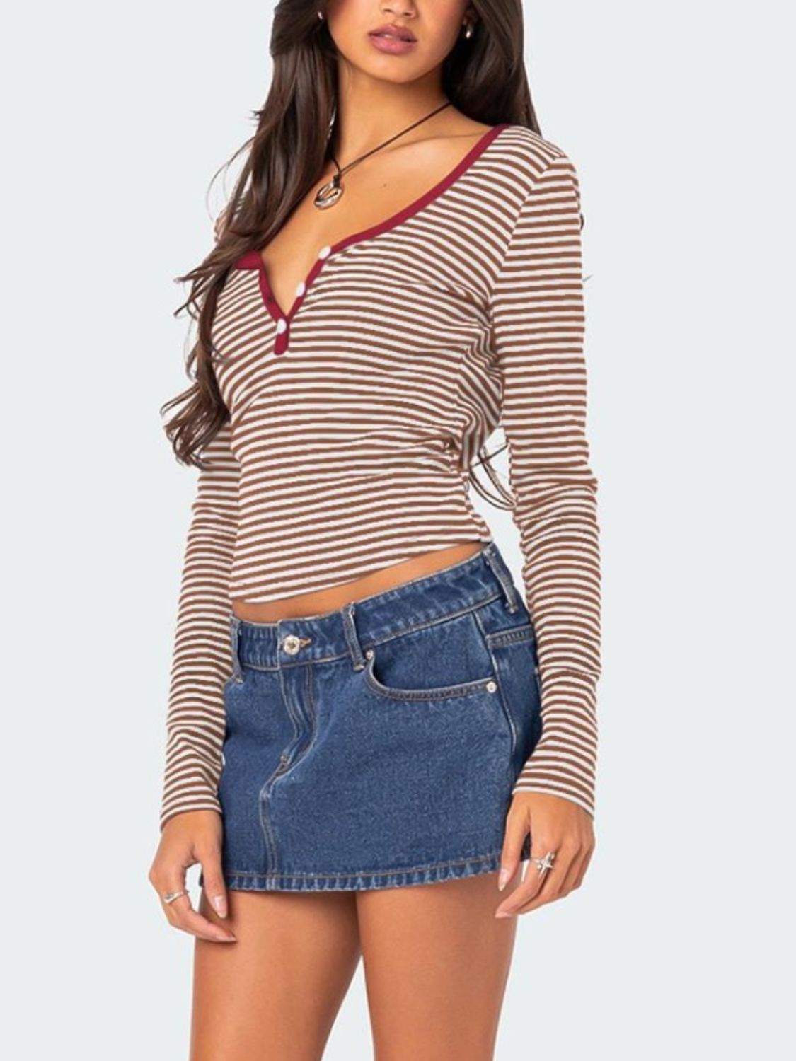 Brown striped T-shirt with maroon trim paired with denim skirt