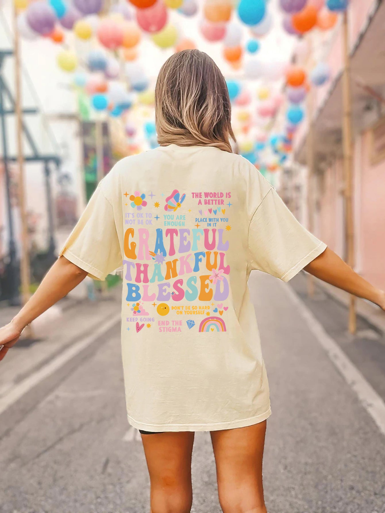 Beige T-shirt with colorful gratitude graphic on back