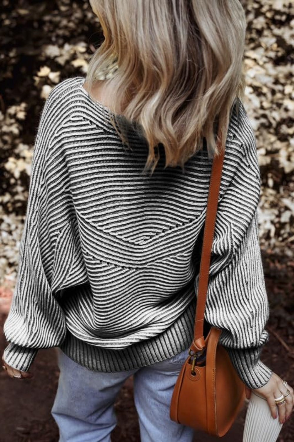 Back view of black and white textured striped long sleeve top