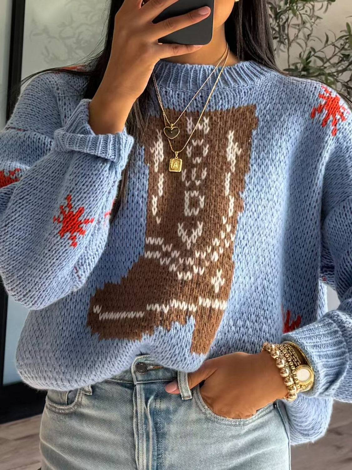 Front view of boot pattern sweater with accessories