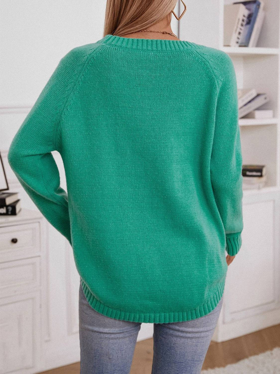 Back view of green raglan sleeve sweater