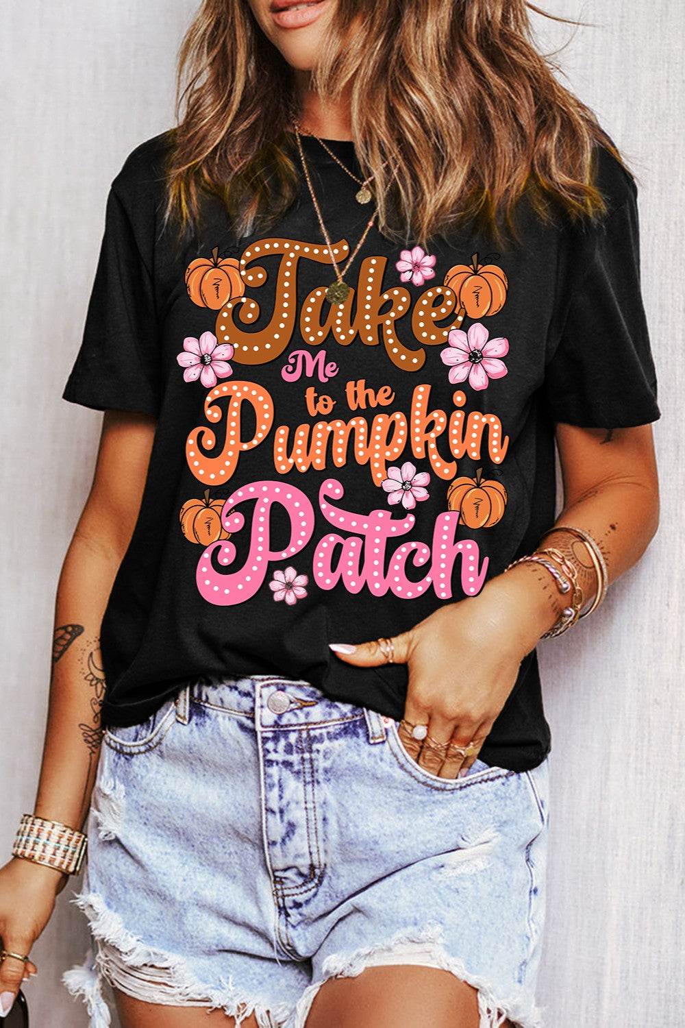 Black T-shirt with pumpkin patch design and denim shorts