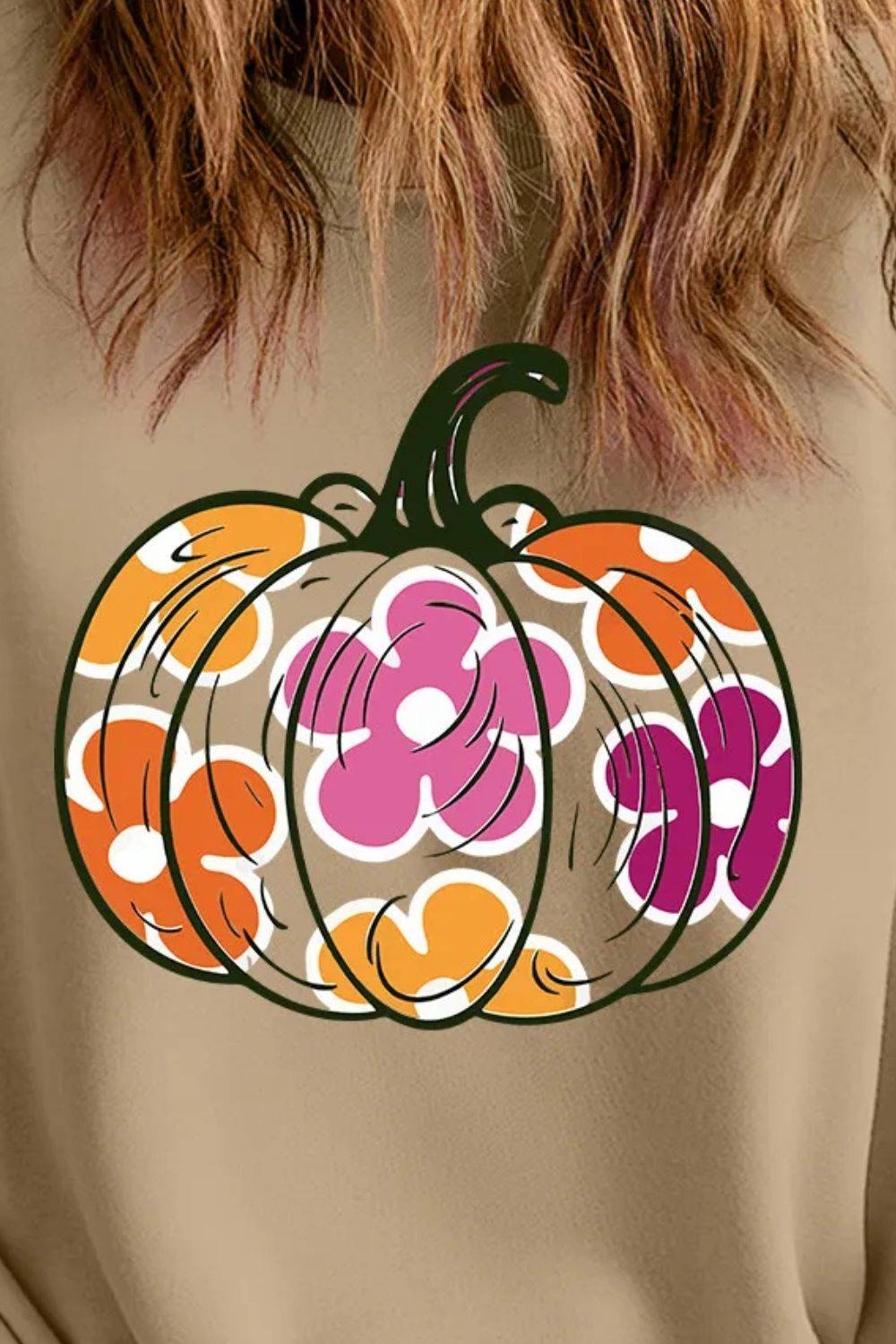 Close-up of pumpkin graphic on sweatshirt