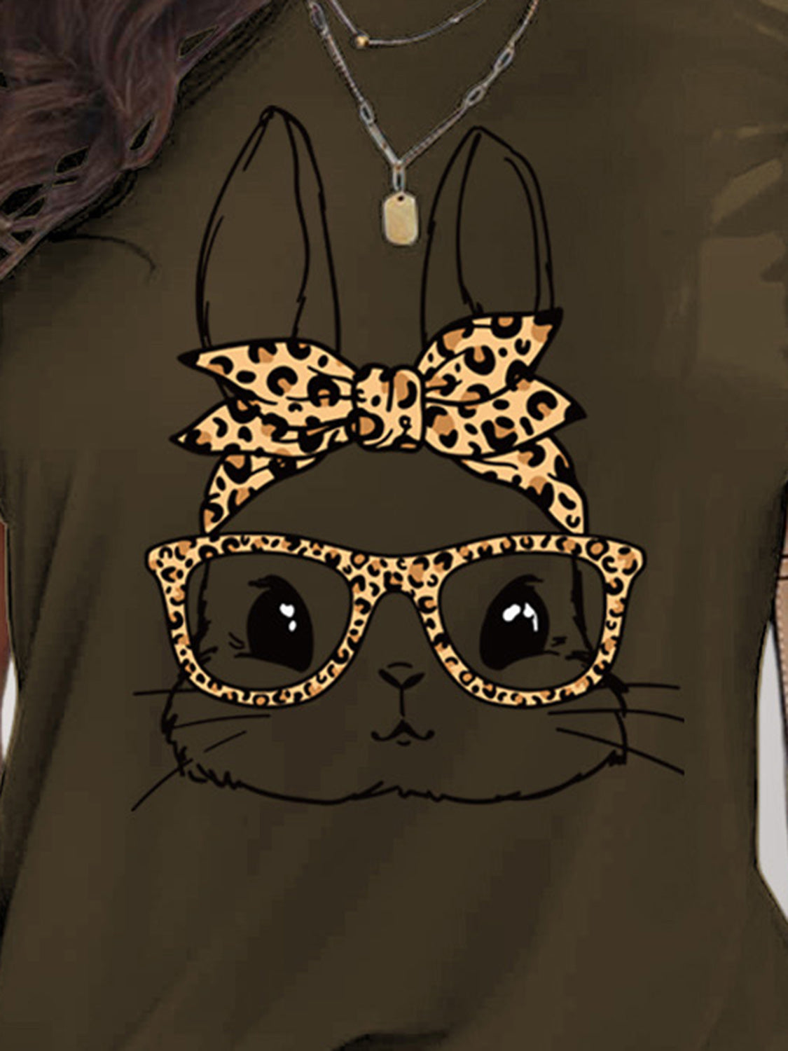 Close-up of rabbit graphic on dark olive T-shirt
