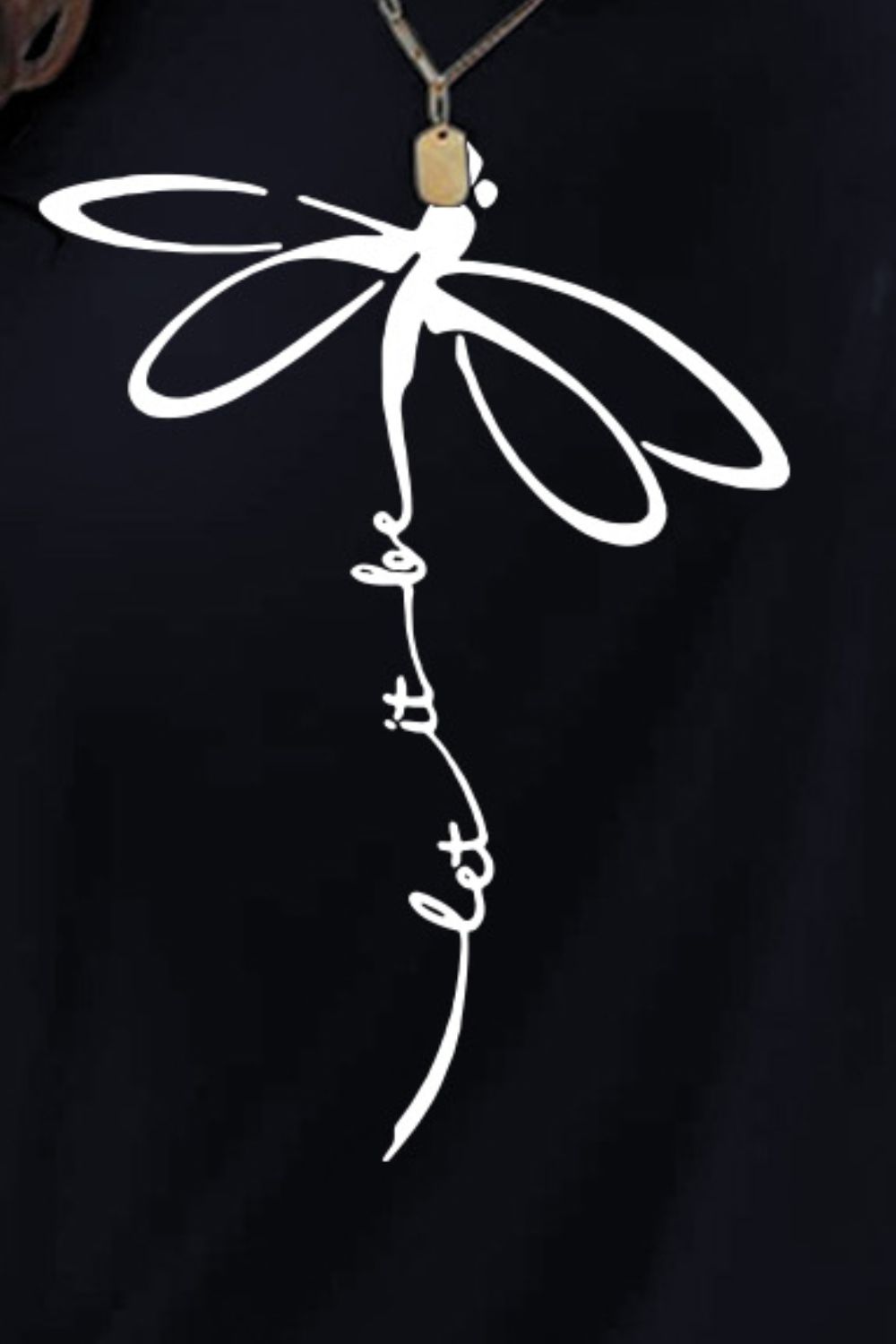 Close-up of dragonfly graphic on black t-shirt