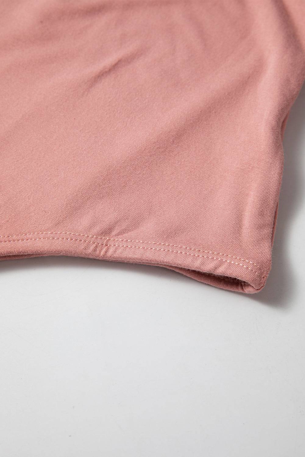 Hem detail of pink V-neck bodysuit