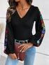 Black V-neck crochet long sleeve top with colorful sleeve accents