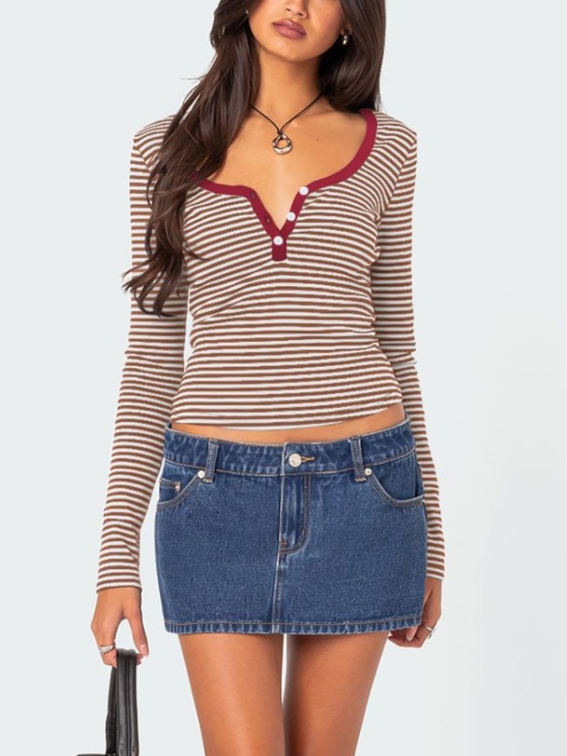 Front view of brown striped T-shirt with maroon trim and denim skirt