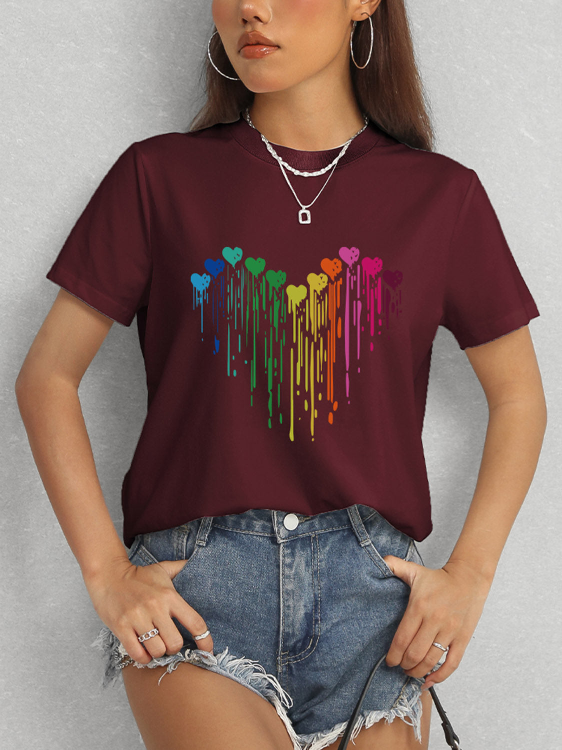 Maroon short sleeve t-shirt featuring colorful heart pattern