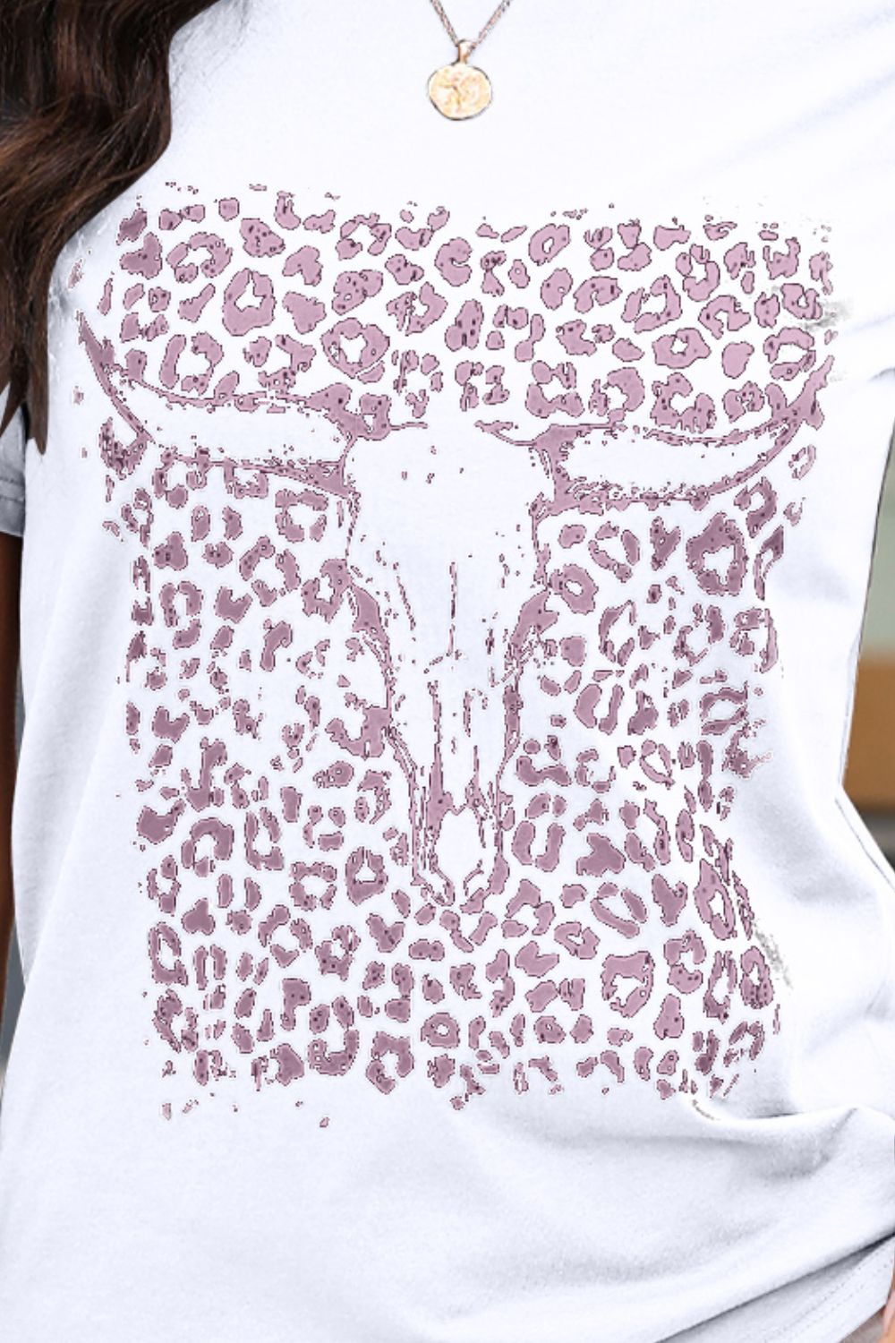 Close-up of white T-shirt with bull skull and leopard print design