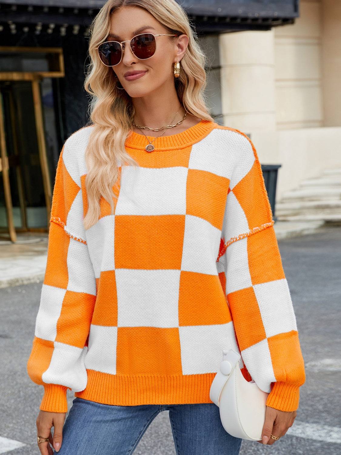 Orange and white checkered round neck sweater