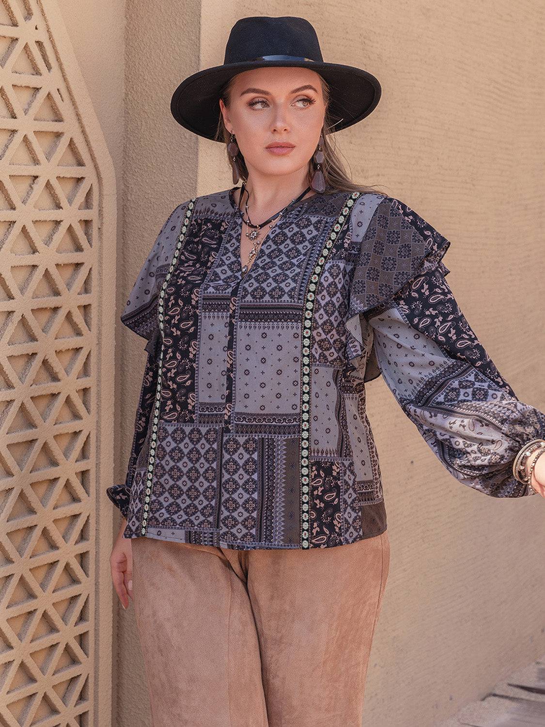 Model wearing ruffled printed blouse with notched neckline