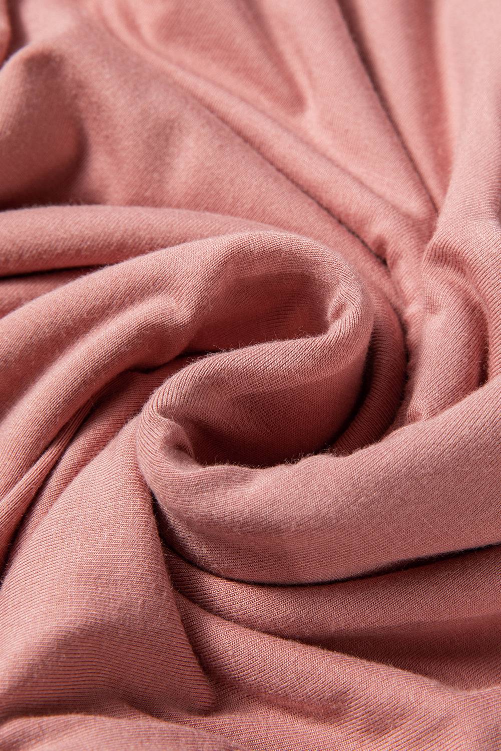 Fabric texture of pink V-neck bodysuit