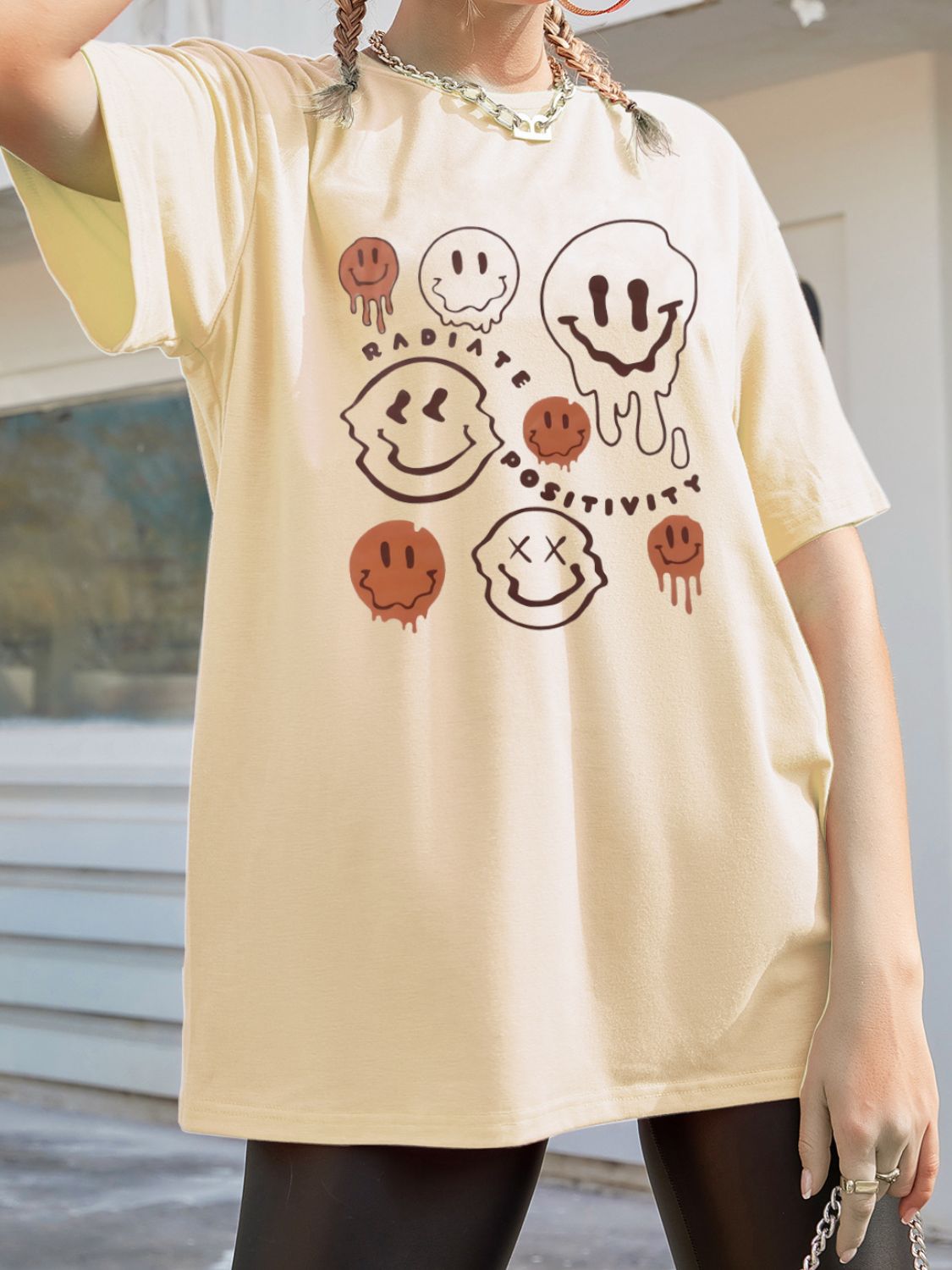 Graphic t-shirt featuring smiley faces and positivity text