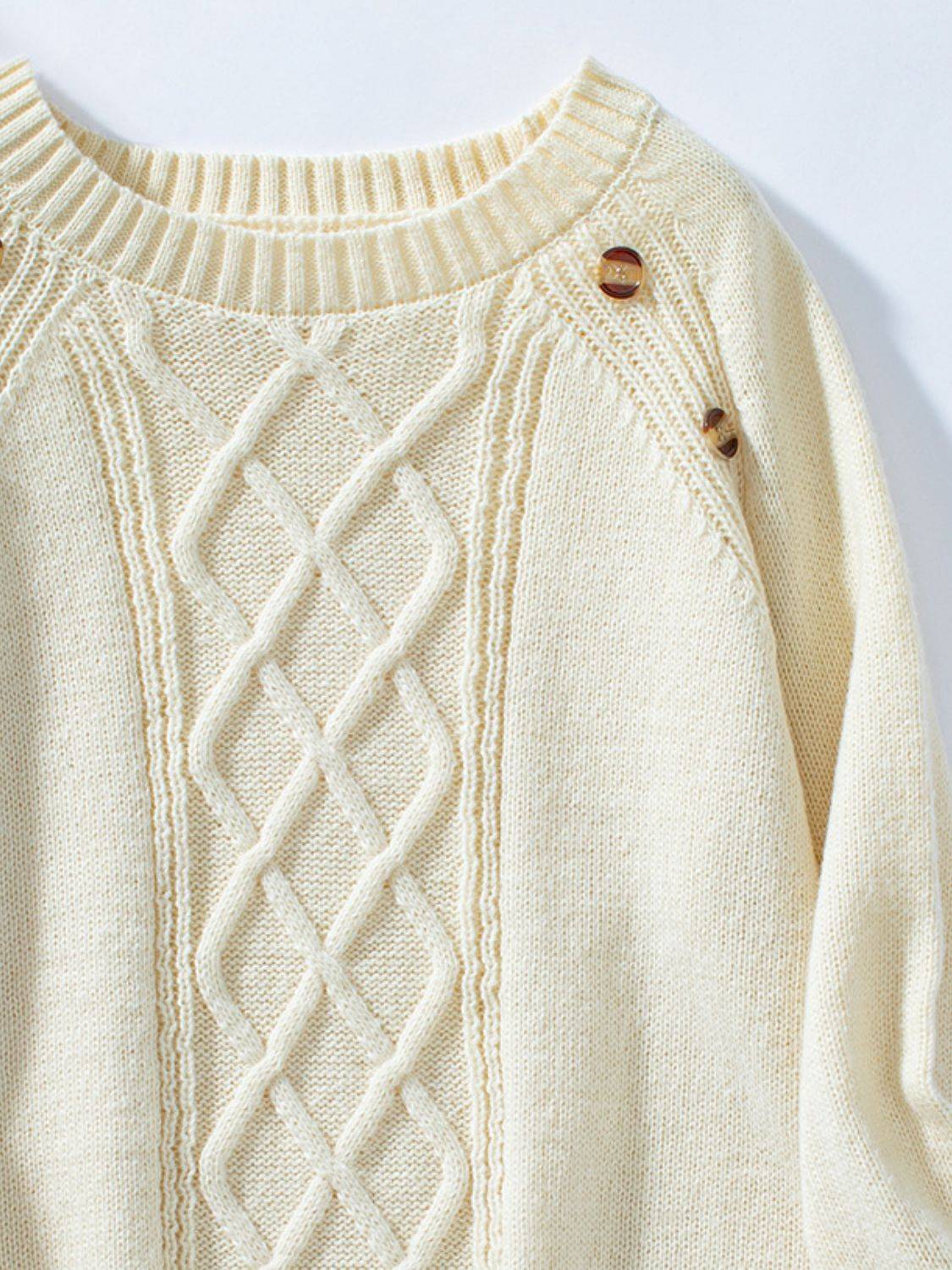 Cream sweater with cable knit and button details