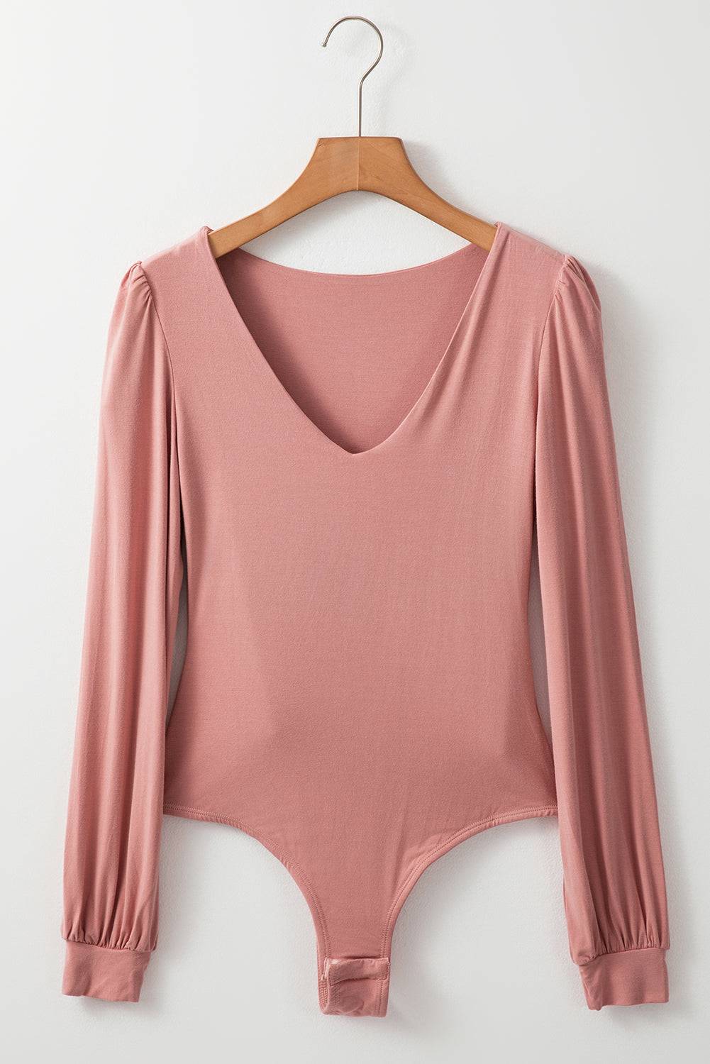Pink V-neck long sleeve bodysuit on hanger