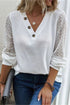 White V-neck long sleeve t-shirt with decorative buttons.