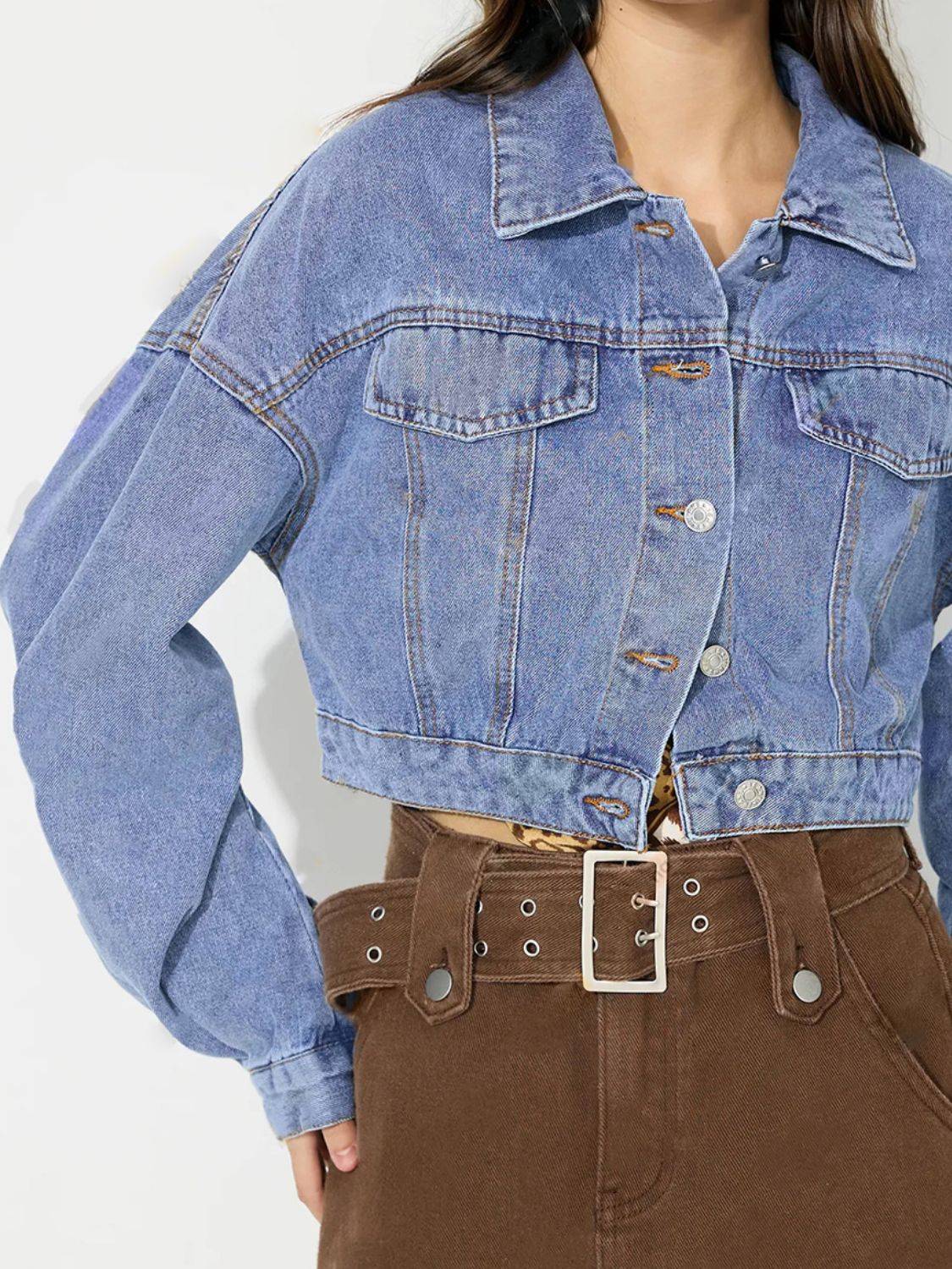 Close-up of collared cropped denim top with buttons.