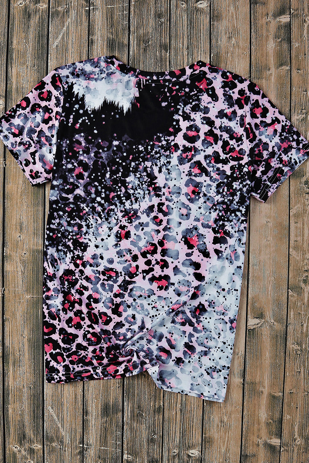 Back of leopard print T-shirt on wood background