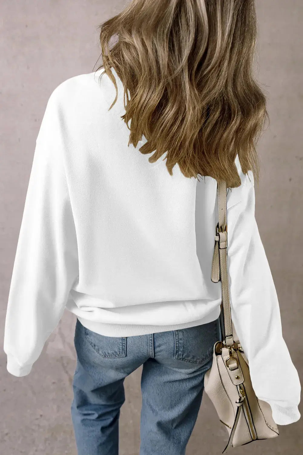 Back view of plain white sweatshirt with long sleeves.