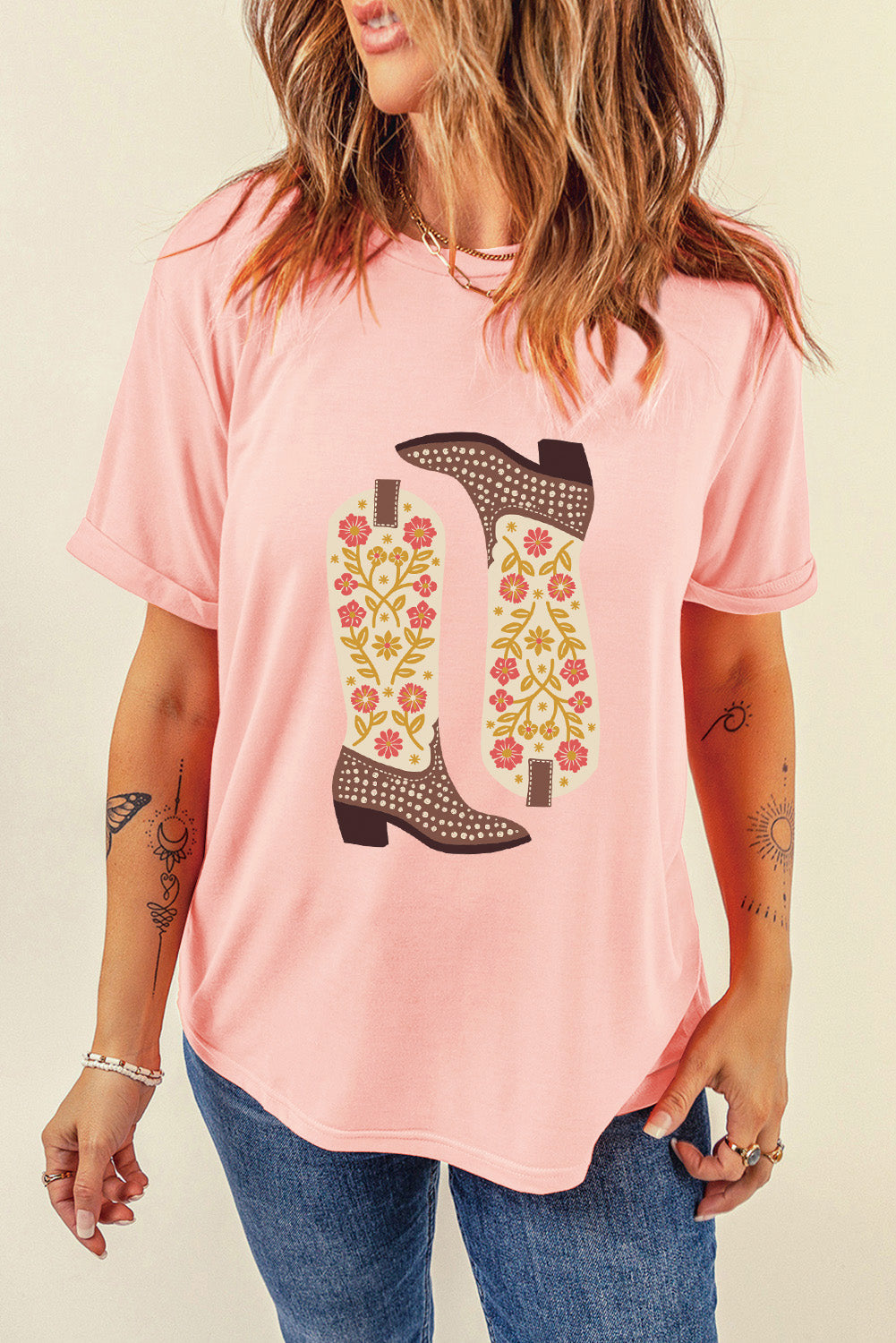 Pink T-shirt featuring floral boot design, round neck