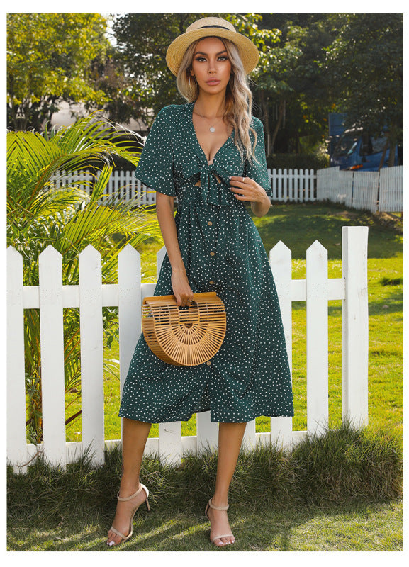 Gepunktetes, tiefes V-Ausschnitt, hohles, kurzärmliges, sexy Kleid mit Schleife