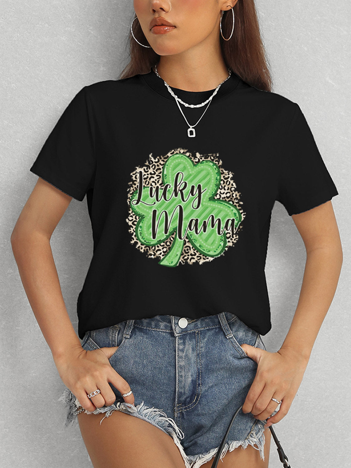 Model wearing black Lucky Mama t-shirt and denim shorts