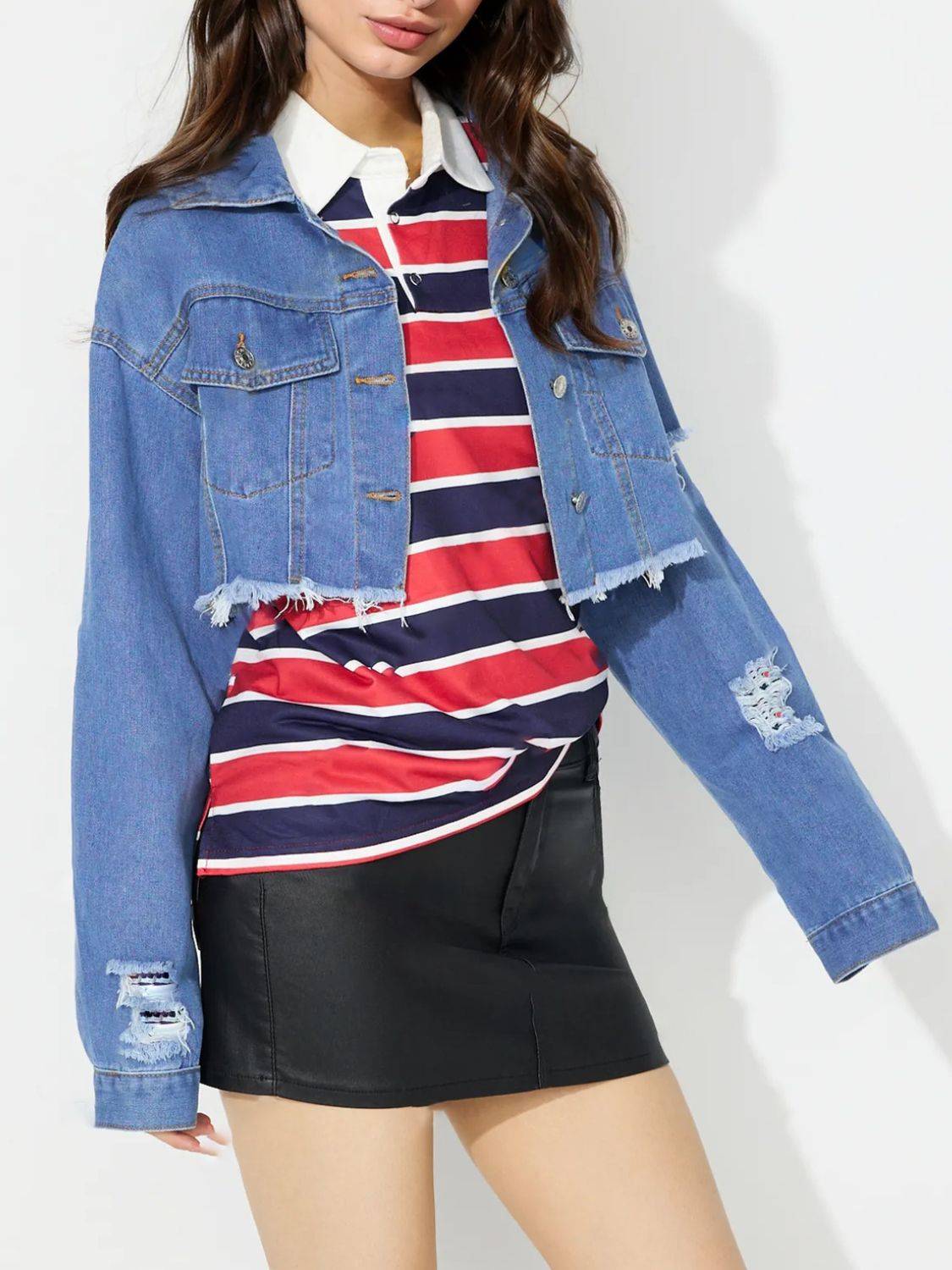 Cropped denim top with raw hem, paired with striped shirt.