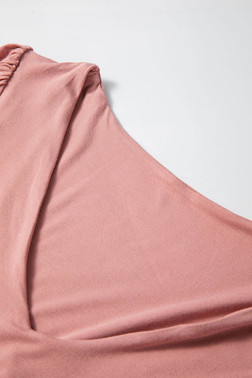 Close-up of V-neck detail on pink bodysuit