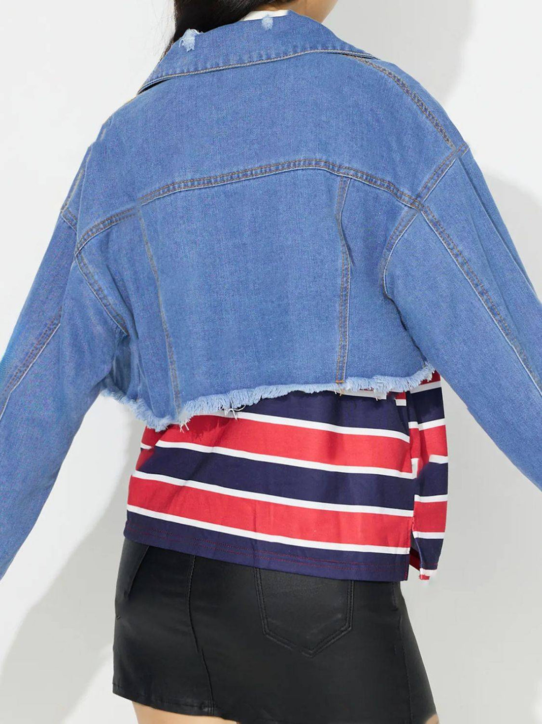 Back view of raw hem collared denim top over striped shirt.