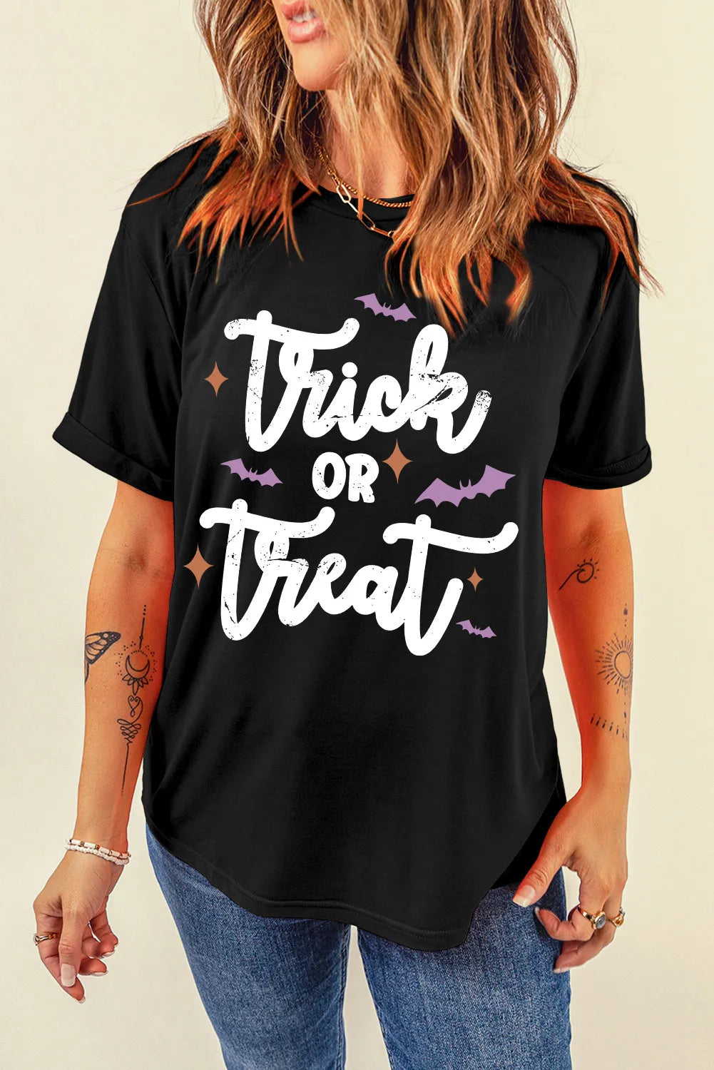 Black Trick or Treat graphic T-shirt, front view with tattoos