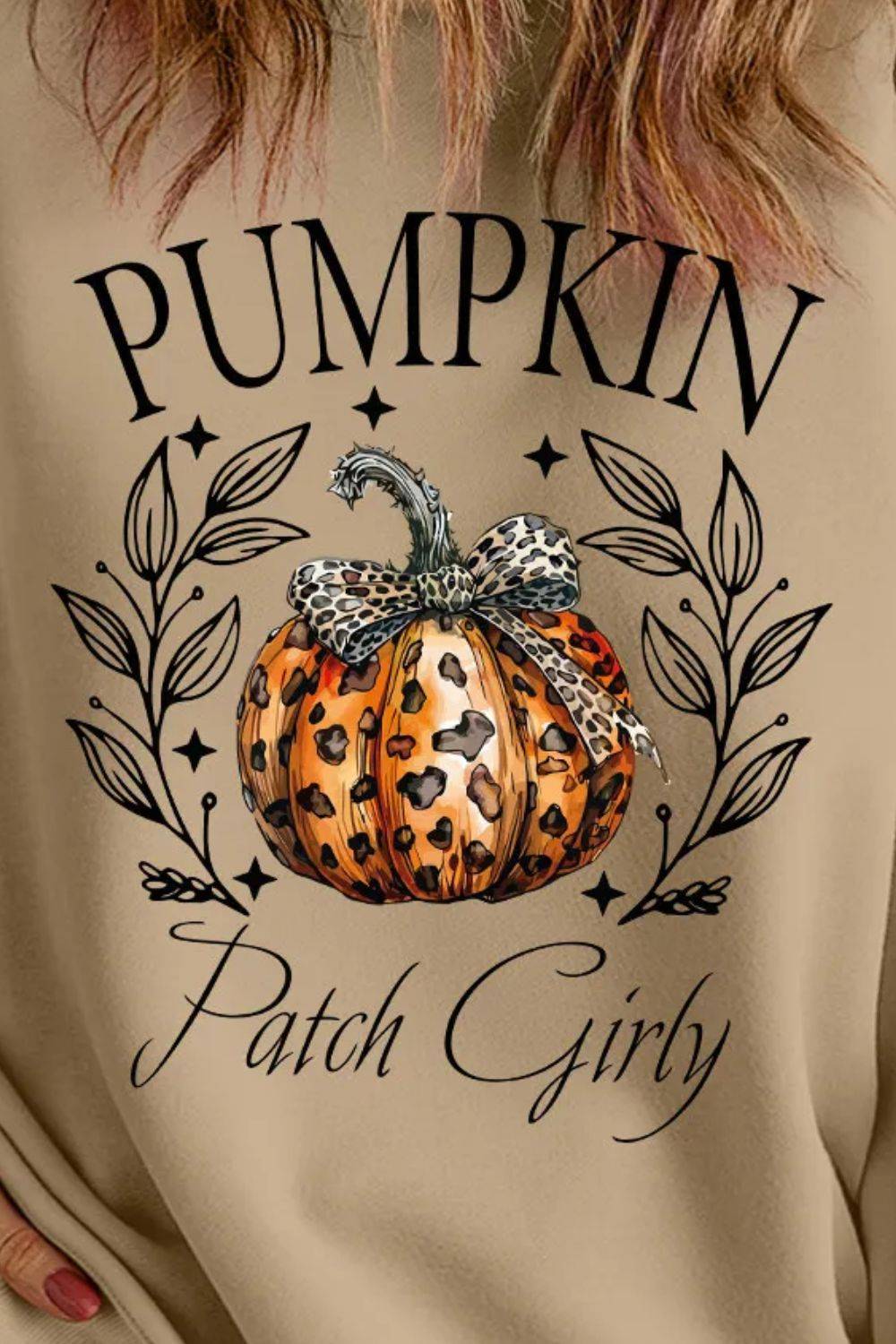 Close-up of pumpkin graphic on sweatshirt