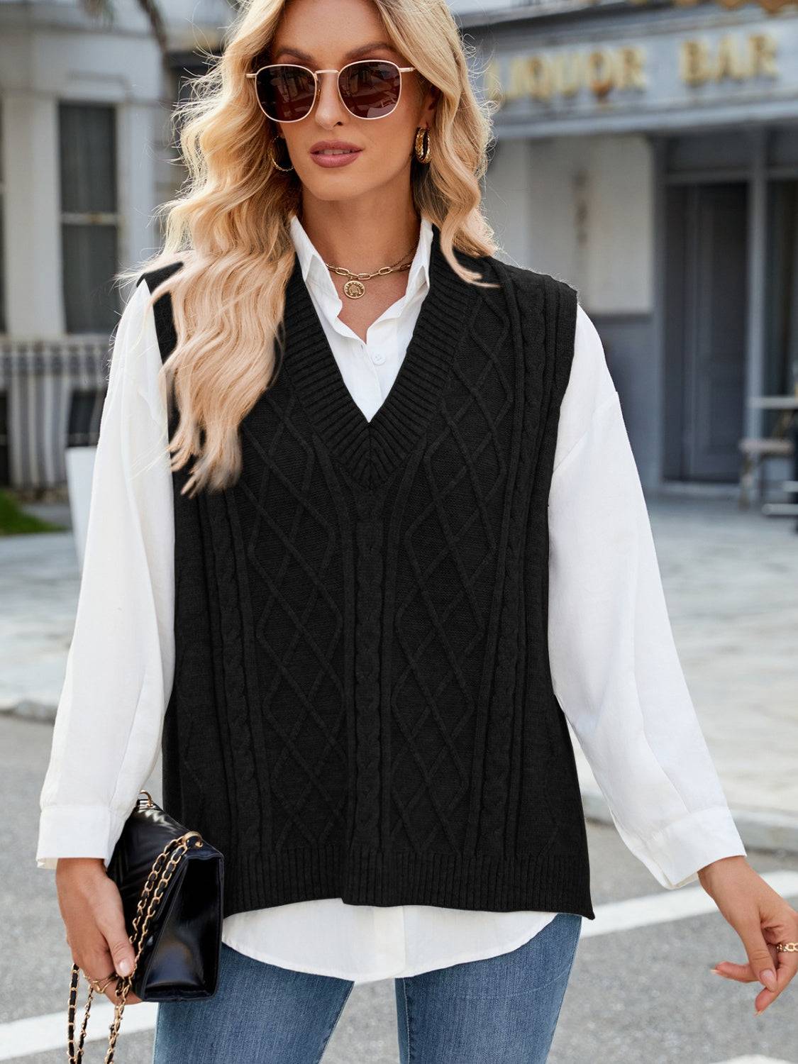 Black cable knit V-neck sweater vest with sunglasses