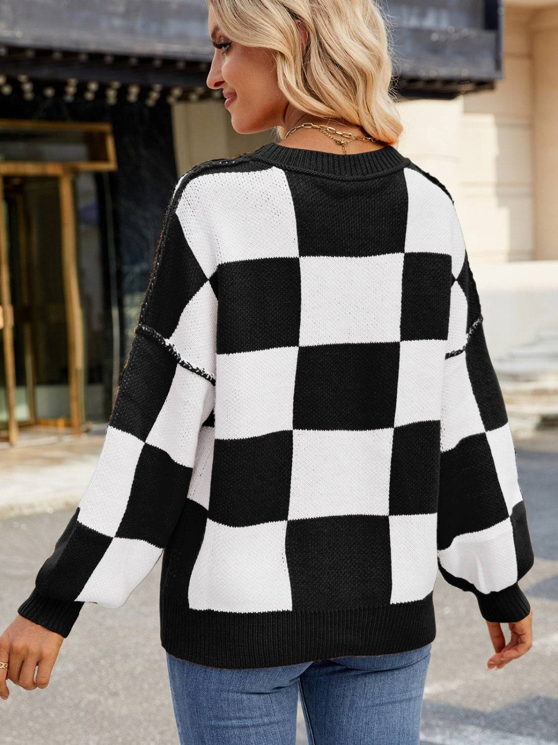 Back view of black and white checkered sweater