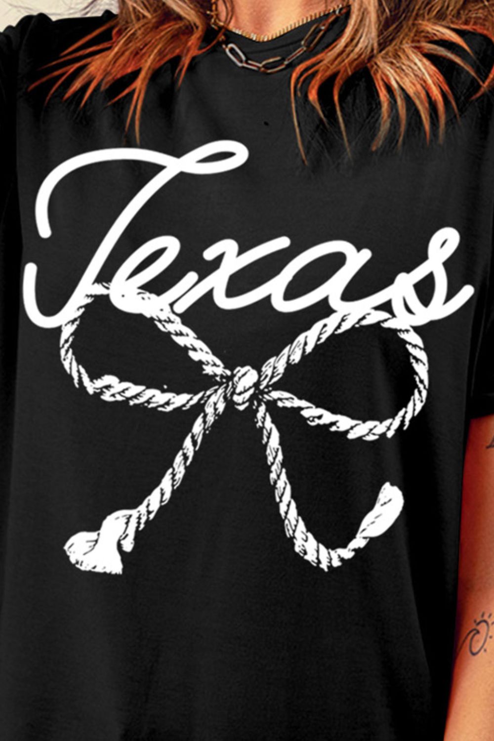 Close-up of Texas rope graphic on black T-shirt