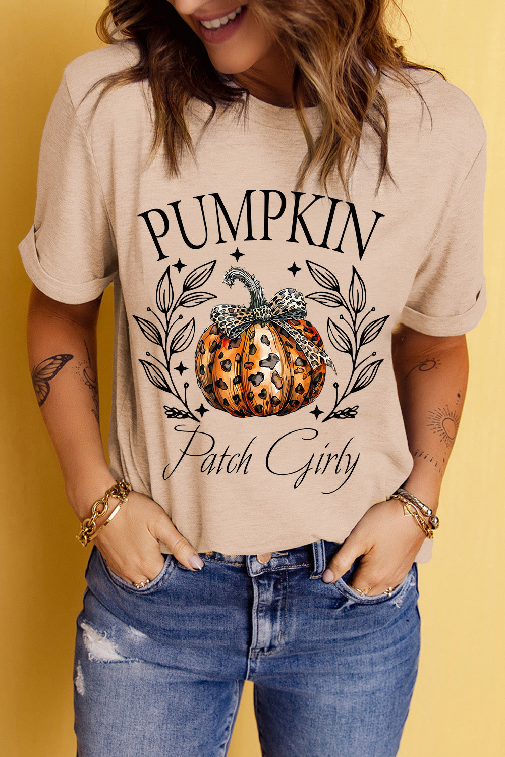 Front view of pumpkin graphic t-shirt with rolled sleeves