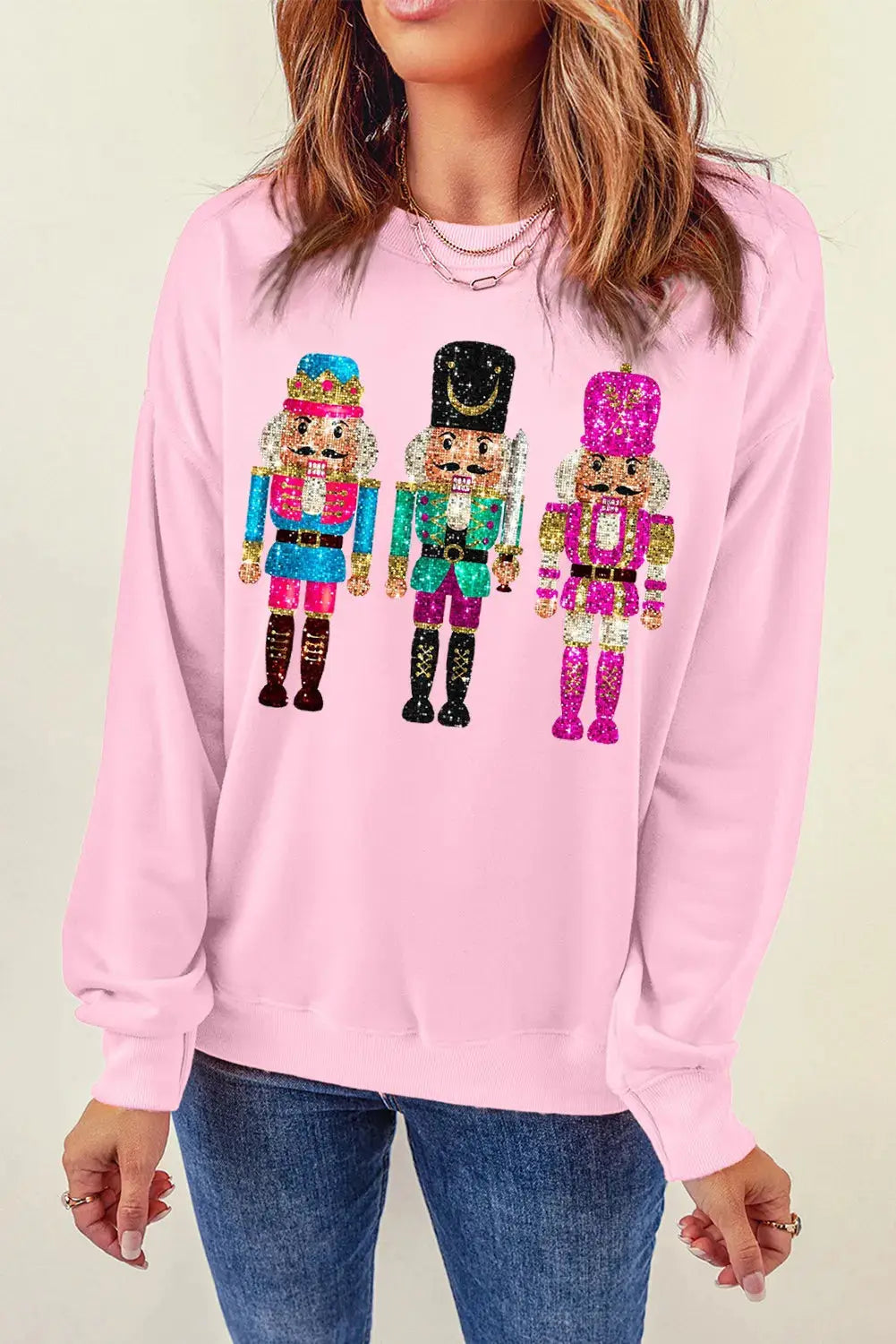 Round neck pink sweatshirt featuring nutcracker design