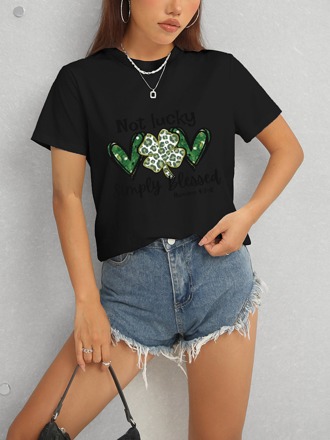 Black T-shirt with green heart clover design