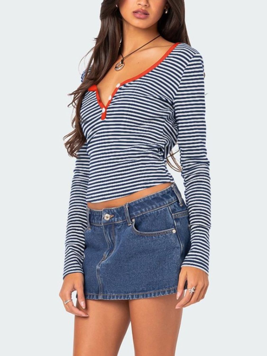 Navy striped T-shirt with red trim paired with denim skirt